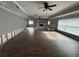 Large living room featuring a stone fireplace and modern ceiling fans at 1801 Hibiscus S Ct, Oldsmar, FL 34677