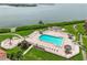 Waterfront property features an outdoor pool, lounge chairs, and tropical landscaping at 6218 Palma Del Mar S Blvd # 103, St Petersburg, FL 33715