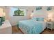 Comfortable bedroom with bright decor and a large window that offers outdoor views at 6218 Palma Del Mar S Blvd # 103, St Petersburg, FL 33715