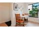Cozy dining nook featuring a white table, wooden chairs, and a window showcasing lush greenery outside at 6218 Palma Del Mar S Blvd # 103, St Petersburg, FL 33715