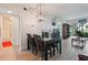Bright dining room with a modern light fixture, a table for four, and a view into the living area at 6218 Palma Del Mar S Blvd # 103, St Petersburg, FL 33715