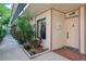 Charming condo entrance with a welcoming door mat, plants, and pleasant decor at 6218 Palma Del Mar S Blvd # 103, St Petersburg, FL 33715