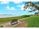 Waterfront property features scenic walkway, lush greenery, and calming bench seating at 6218 Palma Del Mar S Blvd # 103, St Petersburg, FL 33715