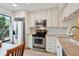 Well-equipped kitchen with stainless steel appliances, granite counters, and white cabinetry at 6218 Palma Del Mar S Blvd # 103, St Petersburg, FL 33715