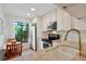 Bright kitchen with stainless steel appliances, granite countertops, white cabinets, and an eat-in dining nook near a large window at 6218 Palma Del Mar S Blvd # 103, St Petersburg, FL 33715