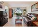 Cozy living room features a comfortable leather couch, stylish decor, and access to an outdoor patio at 6218 Palma Del Mar S Blvd # 103, St Petersburg, FL 33715