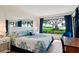 Serene bedroom with a large window offering picturesque green space and water views at 6218 Palma Del Mar S Blvd # 103, St Petersburg, FL 33715