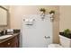 Charming half bath with wood vanity, granite countertop, decorative shelves, and neutral walls at 4239 Brentwood Park Cir, Tampa, FL 33624