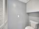 Updated bathroom has storage shelves and access to the hallway at 4239 Brentwood Park Cir, Tampa, FL 33624