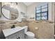 Updated bathroom features framed mirror, stylish vanity, and decorative tile accent at 4239 Brentwood Park Cir, Tampa, FL 33624