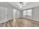 Spacious bedroom with wood-look floors, a ceiling fan, and ample natural light from the window at 4239 Brentwood Park Cir, Tampa, FL 33624