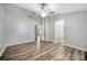 Large bedroom featuring wood-look floors, a ceiling fan, and doorways leading to other rooms at 4239 Brentwood Park Cir, Tampa, FL 33624