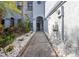Charming entrance walkway adorned with decorative stones and lush plants leading to the front door at 4239 Brentwood Park Cir, Tampa, FL 33624