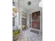 Inviting front porch features decorative ironwork, tile flooring and is adorned with potted flowers at 4239 Brentwood Park Cir, Tampa, FL 33624