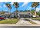 Charming townhome featuring mature palm trees, a private driveway, and manicured landscaping at 4239 Brentwood Park Cir, Tampa, FL 33624