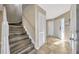 Welcoming foyer with wood-look tile floors, coat closet, and staircase leading to the upper level at 4239 Brentwood Park Cir, Tampa, FL 33624