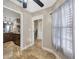 Hallway with tan tiling, white trim, and views of the kitchen and stairs at 4239 Brentwood Park Cir, Tampa, FL 33624