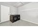 Laundry room area inside the garage includes washer and dryer with overhead shelving at 4239 Brentwood Park Cir, Tampa, FL 33624