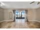 Living room with tile floor, mirror, and view to a screened patio at 4239 Brentwood Park Cir, Tampa, FL 33624