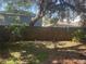 Fenced backyard with sparse groundcover and shady trees at 4706 Dragon Tail Ct, Valrico, FL 33594