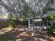 Backyard with a patio, some greenery, and a screened in porch at 4706 Dragon Tail Ct, Valrico, FL 33594