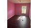 Bright bedroom featuring dark floors, and a window at 4706 Dragon Tail Ct, Valrico, FL 33594
