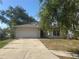 Charming single-Gathering home featuring an attached two-car garage, a well-maintained lawn, and mature trees at 4706 Dragon Tail Ct, Valrico, FL 33594