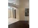 Hallway showcasing tile and wood flooring, along with doorways leading to various rooms at 4706 Dragon Tail Ct, Valrico, FL 33594