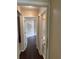 Hallway with hardwood floors leading into a room with a bathroom at 4706 Dragon Tail Ct, Valrico, FL 33594