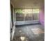 Enclosed patio with screen panels and an aging concrete floor at 4706 Dragon Tail Ct, Valrico, FL 33594