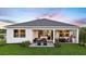 Beautiful backyard with lush lawn, outdoor kitchen, and covered patio perfect for entertaining at 14448 Woodland Preserve Trl, Parrish, FL 34219