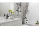 Modern bathroom featuring a white vanity, decorative flowers, and stylish shower and tub at 14448 Woodland Preserve Trl, Parrish, FL 34219