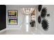 Bright entryway with gray walls, modern art pieces, decorative ceiling detail, and wood accent wall at 14448 Woodland Preserve Trl, Parrish, FL 34219