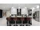 Contemporary kitchen features an island with seating, modern fixtures, and sleek, stainless appliances at 14448 Woodland Preserve Trl, Parrish, FL 34219