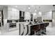 Modern, spacious kitchen with stylish waterfall island, sleek white cabinetry, and stainless steel appliances at 14448 Woodland Preserve Trl, Parrish, FL 34219
