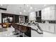 Bright, modern kitchen with island seating, sleek countertops, and decorative hanging lights at 14448 Woodland Preserve Trl, Parrish, FL 34219