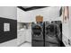 Well-equipped laundry room with modern appliances, bright white cabinets, and functional countertop space at 14448 Woodland Preserve Trl, Parrish, FL 34219
