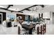 Bright living room with sleek tile floors and an open floor plan to the dining and kitchen area at 14448 Woodland Preserve Trl, Parrish, FL 34219