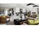 Open-concept living room with views of the kitchen, modern decor, and comfortable seating at 14448 Woodland Preserve Trl, Parrish, FL 34219