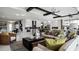 Open-concept living room with views of the kitchen, modern decor, and comfortable seating at 14448 Woodland Preserve Trl, Parrish, FL 34219