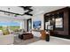 Stylish living room features a TV, modern decor, and large windows with beautiful outdoor views at 14448 Woodland Preserve Trl, Parrish, FL 34219