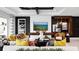 Comfortable living room with modern decor, black ceiling beams, stylish artwork, and ample seating at 14448 Woodland Preserve Trl, Parrish, FL 34219