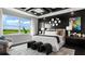 Well-appointed main bedroom featuring tray ceiling, a large window with a scenic view, and stylish decor at 14448 Woodland Preserve Trl, Parrish, FL 34219