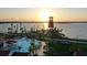 Stunning aerial view of a community pool, lake, and waterfront tower at sunset at 42850 Park View Dr, Punta Gorda, FL 33982
