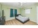 Bedroom with wood-look floors, natural light, and a calming ambiance for relaxation at 6310 Cecelia Dr, New Port Richey, FL 34653