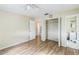 Spacious bedroom with hardwood floors, ceiling fan, and ample closet space, offering comfort at 6310 Cecelia Dr, New Port Richey, FL 34653