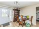 Cozy dining area with wood-style flooring, a charming wooden table, and a curio cabinet at 6310 Cecelia Dr, New Port Richey, FL 34653