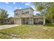 Two-story home featuring a single-car garage and covered front porch at 6310 Cecelia Dr, New Port Richey, FL 34653