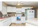 Functional kitchen featuring white appliances, ample counter space, and brick backsplash at 6310 Cecelia Dr, New Port Richey, FL 34653
