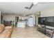 Spacious living area with open flow to kitchen featuring modern lighting at 6310 Cecelia Dr, New Port Richey, FL 34653